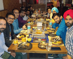 Nascenture employees gathered around a long table, enjoying a team meal and celebrating together.