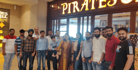 Nascenture employees posing outside a buffet restaurant, enjoying a team outing and bonding over a shared meal.